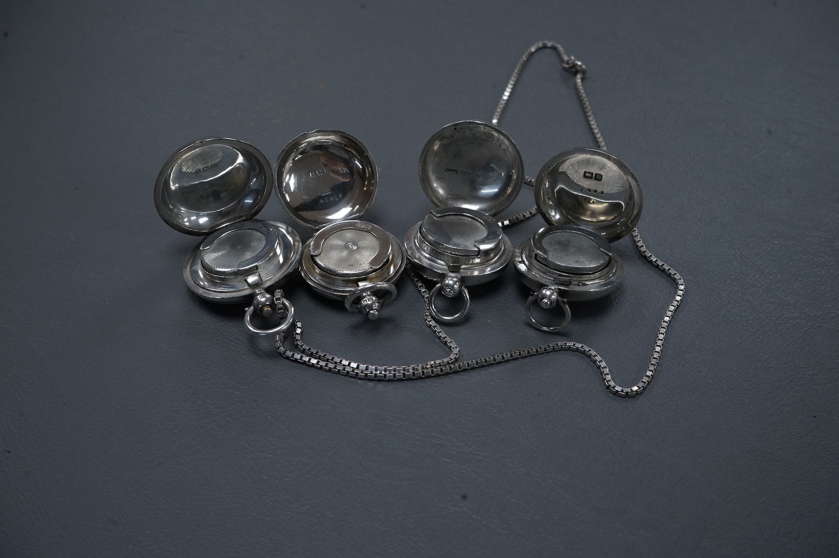 Two late Victorian plain silver sovereign cases and two George V silver sovereign cases, including engine turned, Birmingham, 1913, with a later associated silver chain.